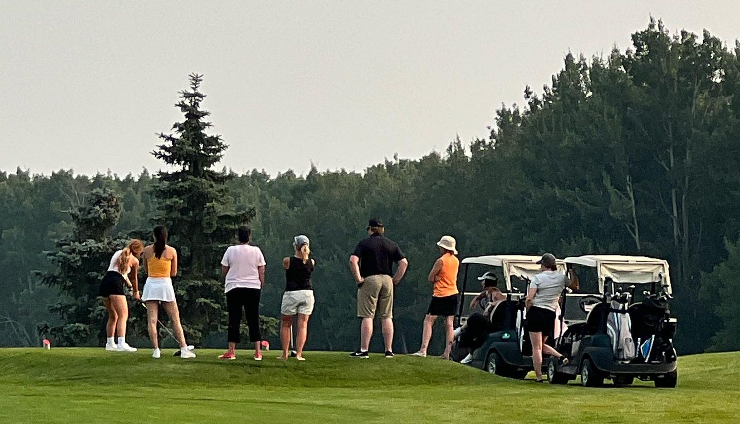 Golfers on golf course observing event